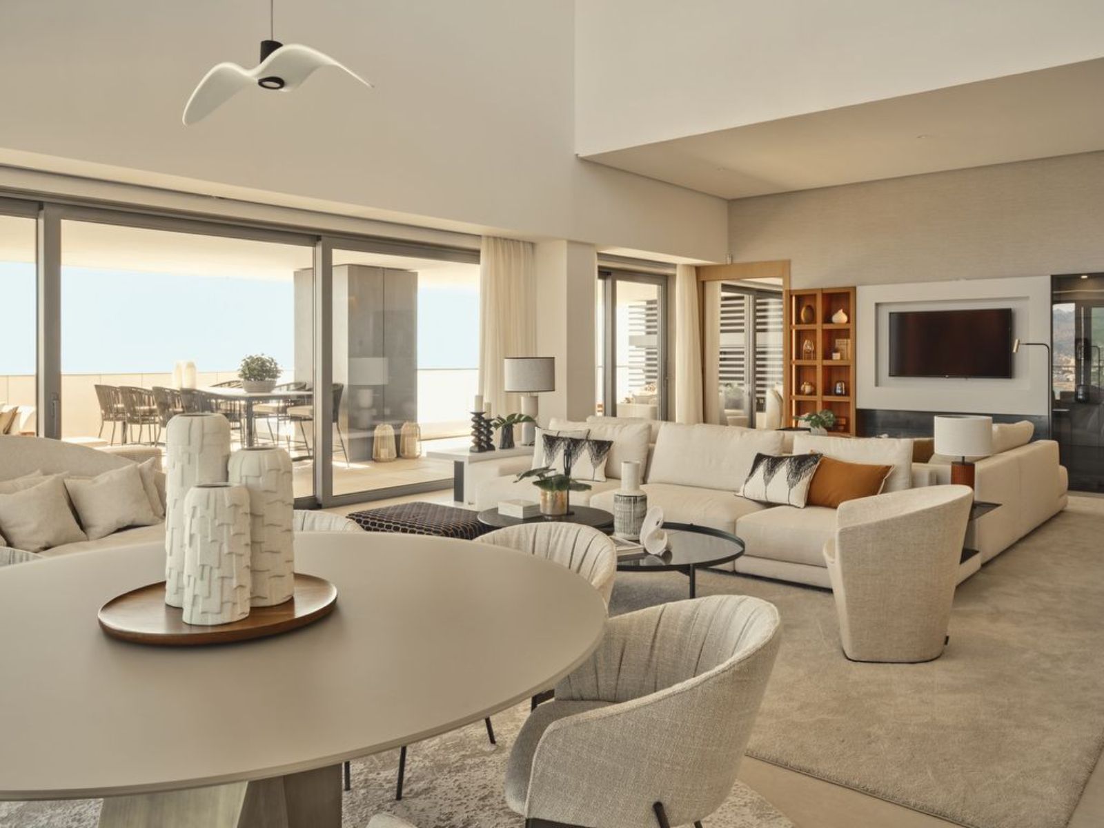 Spacious and modern living room in Malaga Towers with large windows and stylish furniture.